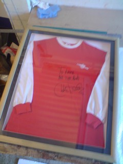 Old Arsenal signed and framed football shirt.