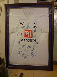Signed Tottenham football team shirt framing.