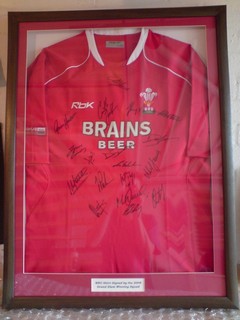 WRU signed rugby shirt by the 2008 grand slam winning squad.